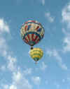 Two Balloons Float Soundlessly Overhead
